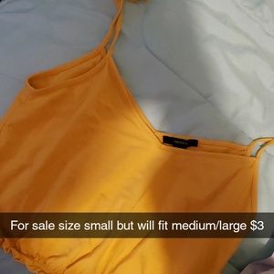 Yellow crop tank size small but could fit medium /large